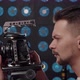 European Male Videographer Sets Up a Video Camera to Shoot in the Studio - VideoHive Item for Sale