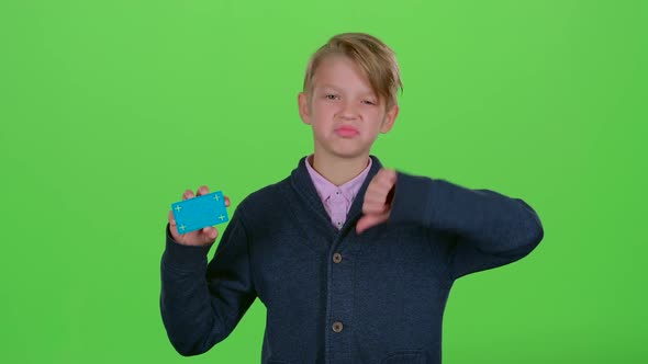 Teen Boy with a Credit Card Shows Dislike and Then Like on a Green Screen
