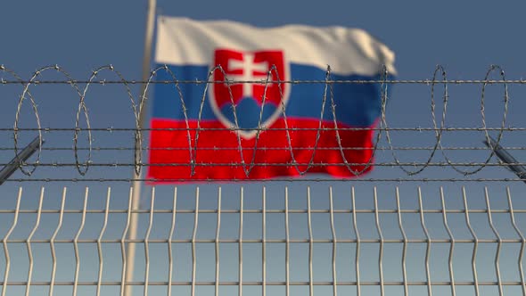 Waving Flag of Slovakia Behind Barbed Wire