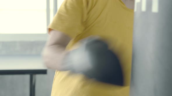 Asian senior workout boxing training in the gym, old man exercise for strength with punch.