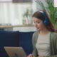 Happy Young Woman Wearing Headphones Talking to Laptop Making Distance Online Video Conference Call - VideoHive Item for Sale