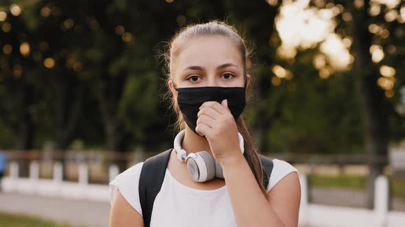 Happy Girl Takes Off Black Protective Mask From Face