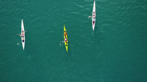 Aerial video of three canoes cruising along Wallensee Lake in Switzerland during Summer (1)