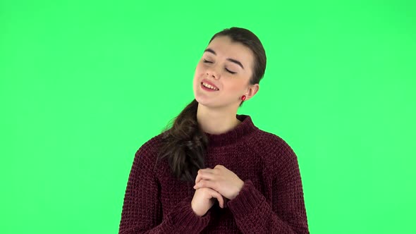 Lovely Girl Daydreaming and Smiling Looking Up. Green Screen