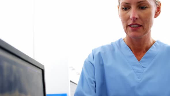 Dentist and dental assistant discussing a x-ray on the monitor