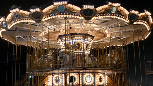 Illuminated Merry Go Round in Park. Brightly Illuminated Roundabout Spinning in Wonderful Amusement