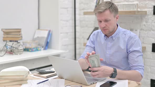 Businessman Counting Dollar and Looking Confused