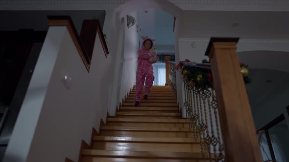 Wide Shot Stairs with Cheerful Cute Girl Walking Down in Slow Motion Holding Teddy Bear