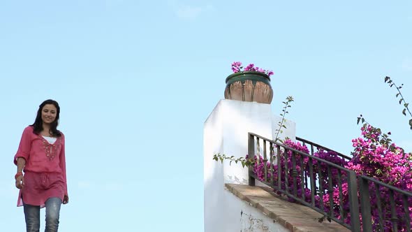 Young woman walking down steps