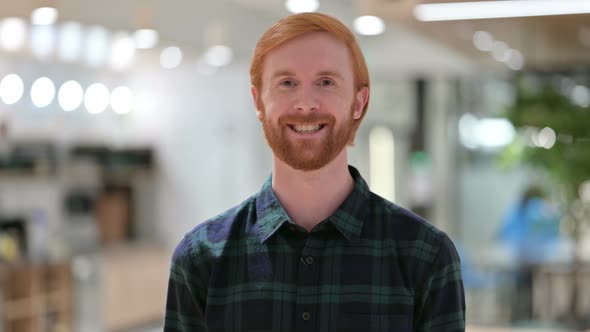 Portrait of Young Beard Redhead Man Smiling at Camera