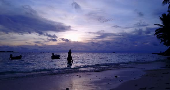 Happy man and woman on honeymoon vacation live the dream on beach on summer white sandy background 