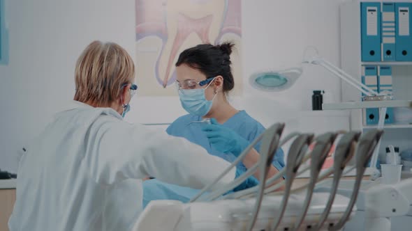 Nurse and Stomatologist Examining Teeth of Patient