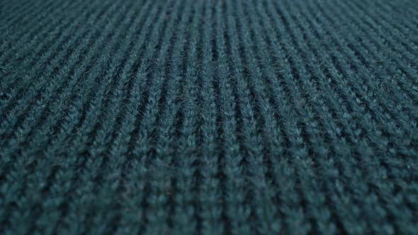 Cozy sheep wool tidewater color fabric texture in macro. Teal handcraft knitting woolen sweater