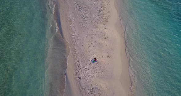 Luxury birds eye copy space shot of a summer white paradise sand beach and blue water background in 