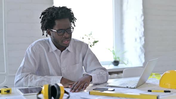 African Engineer Doing Paperwork in Office