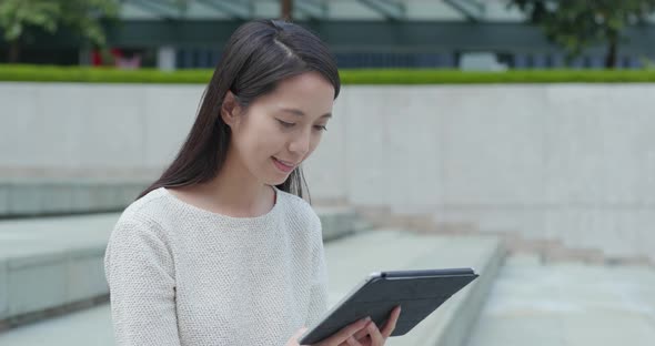 Woman use of tablet computer in city