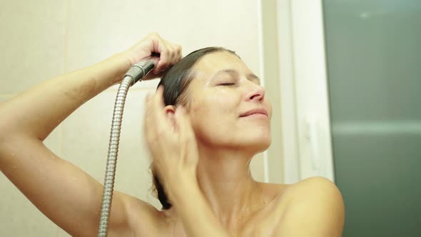 Woman Washes Her Hair With Shampoo In The Shower With Hair Care