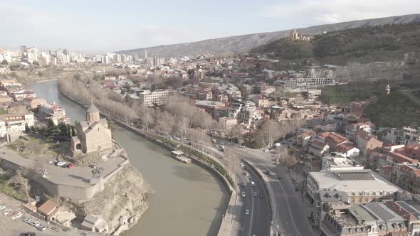 Aerial view of Metekhi church in old Tbilisi located on cliff near river Kura. Georgia 2021 Spring