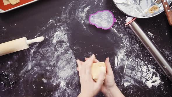 Time lapse. Flat lay. Mother and daughter baking sugar skull cookies for Dia de los Muertos holiday.