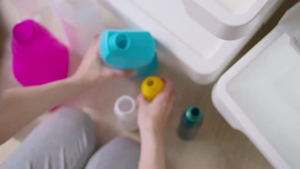 Woman Sorting Plastic Bottles Into a Dumpster