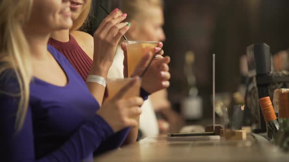 Beautiful Young Ladies Partying, Enjoying Alcoholic Cocktails Near Bar Counter