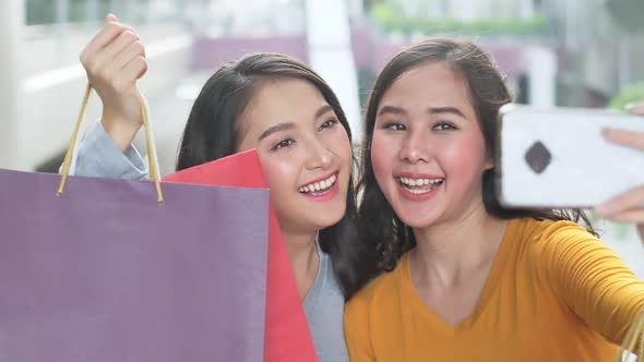 Asian woman wearing face mask. Happy woman with shopping bags