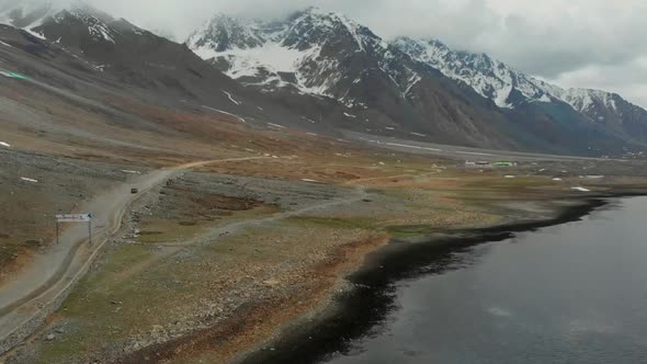 Aerial View Of Rural Expansive Landscape Beside Shandur Lake In Pakistan. Dolly Forward