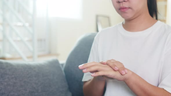 Asian woman using alcohol spray hand sanitizer wash hand for protect coronavirus.