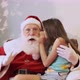 Little girl whispering in Santa's ear. Telling a secret. Revealing the gift you would like to win. - VideoHive Item for Sale