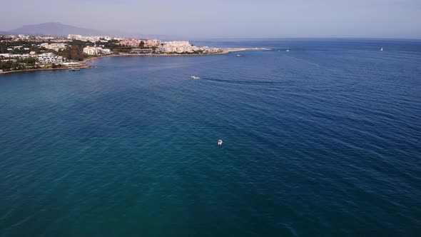 Aerial Over The Alboran Sea In The Costa Del Sol With Pedestal Down To Floating Boat