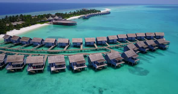 Wide aerial abstract view of a sandy white paradise beach and aqua turquoise water background in 4K