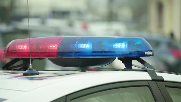 Flashing Flasher on the Roof of a Police Car. Blinker. Close-up.