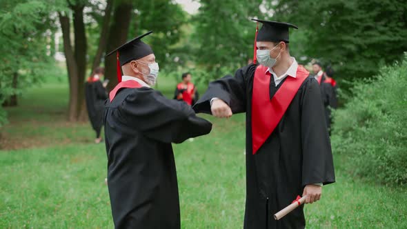 International University Graduation Teacher Congratulates the Man Student on Receiving Her Diploma