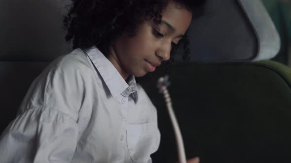 African American Girl Drawing Album at Break Holding Funny Pencil Close Up