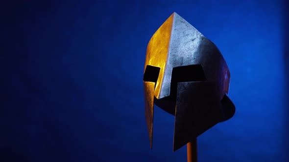 Old Spartan Helmet Isolated on Blue.