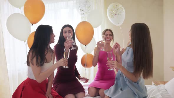 Cheerful Pretty Girls Drinking Champagne at Hen Party