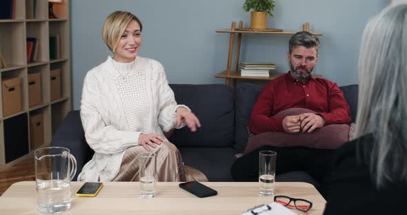 Caucasian Couple Sitting on Couch at Psychologists