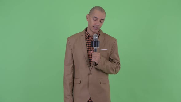 Stressed Bald Multi Ethnic Businessman As Newscaster Looking Tired