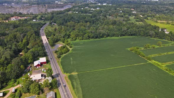 Aerial View of American Countryside Landscape Farmland Farm, Field Near Opencast Mining Quarry in