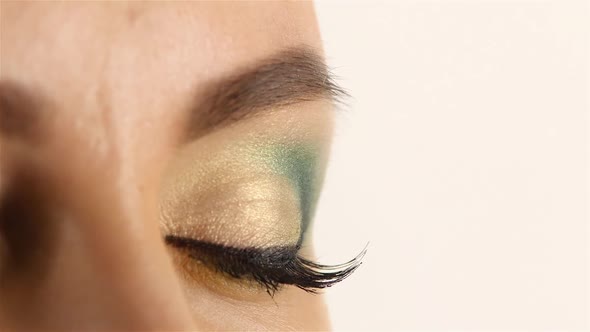 Girl with Bright Make Up, Gray Eyes Open and Closes. White Background. Side View