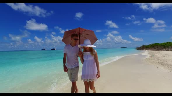 Man and lady tan on beautiful island beach vacation by blue lagoon with white sandy background of th