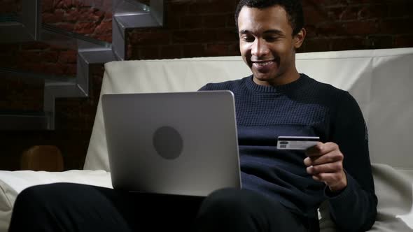 African Man Excited for Successful Online Shopping Transaction of Finance