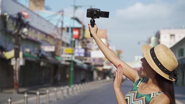 Young Brunette Woman Using a Mobile Phone Takes a Self Video Selfie with Attractive Smile