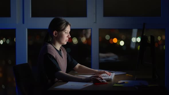 Young Good Looking Caucasian Woman Typing and Working on the Laptop Computer As Freelancer While