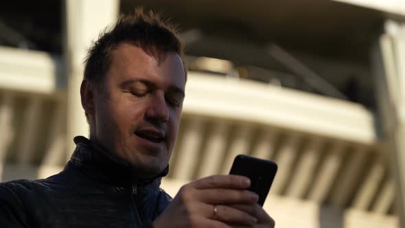 Excited Overjoyed Male Winner Outdoors Celebrating Success Mobile Phone