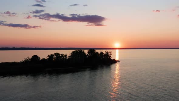 Aerial View of Scenic Red Sunset and Sun Path in Blue Water Surface