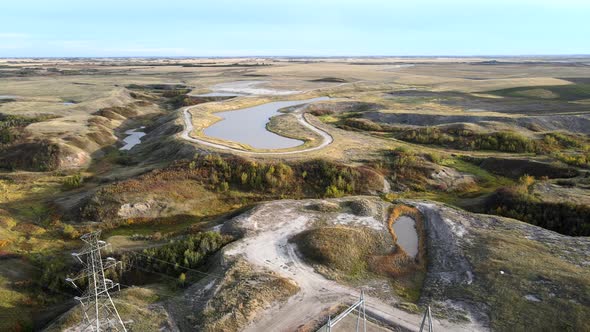 Backwards flight over generating station in north american prairie. Aerial footage of rural power pl