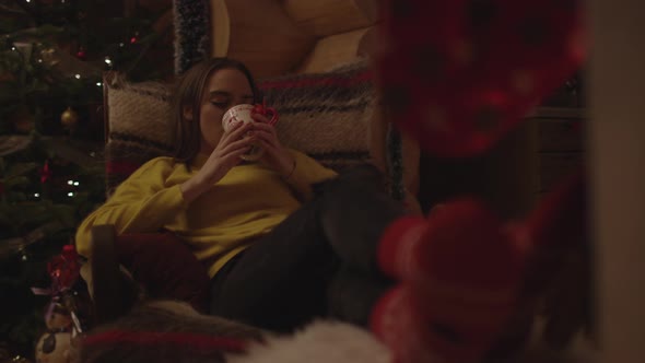 Woman relaxing in an armchair alt