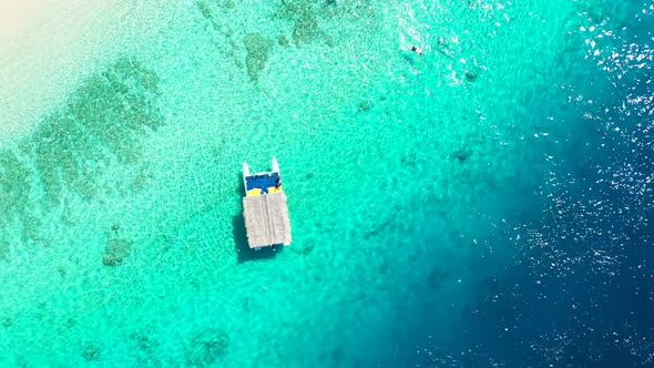 Tropical drone travel shot of a summer white paradise sand beach and blue sea background in vibrant 