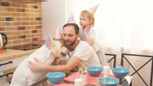 Happy Birthday Funny Dog and Careful Owners in the Kitchen